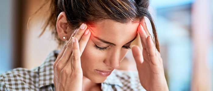 Woman holding temples in pain